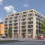 Moderne Stadtecke mit mehrstöckigem Gebäude, Geschäften und belebter Straße bei sonnigem Wetter.