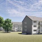 Moderne Mehrfamilienhäuser mit Balkonen, umgeben von Bäumen und Wiesen unter blauem Himmel.